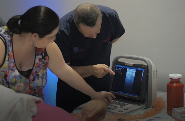 ultrasound guided interventional pain management physician instructor explaining procedure